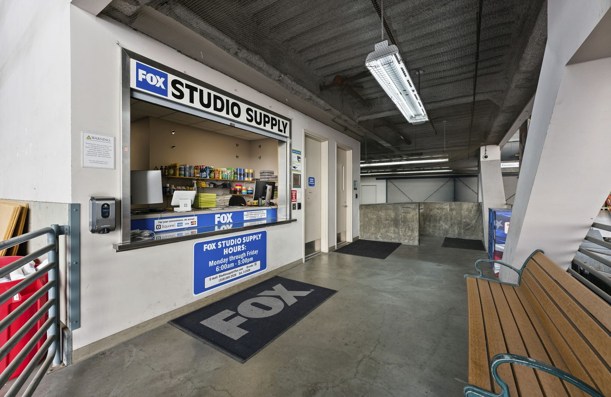 FOX Studio Supply counter and a wooden bench in an industrial-style building.