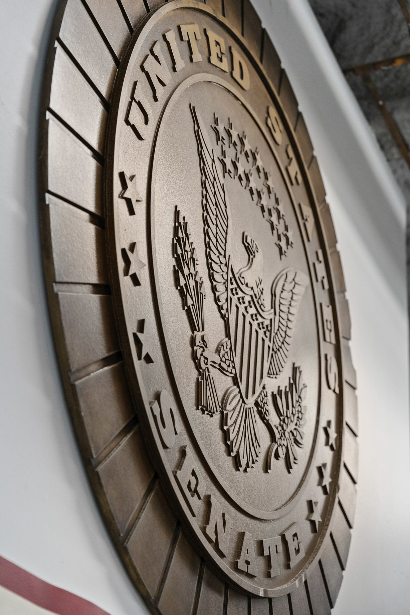 Bronze United States Senate seal, featuring an eagle, stars, and the words 'UNITED STATES SENATE'.