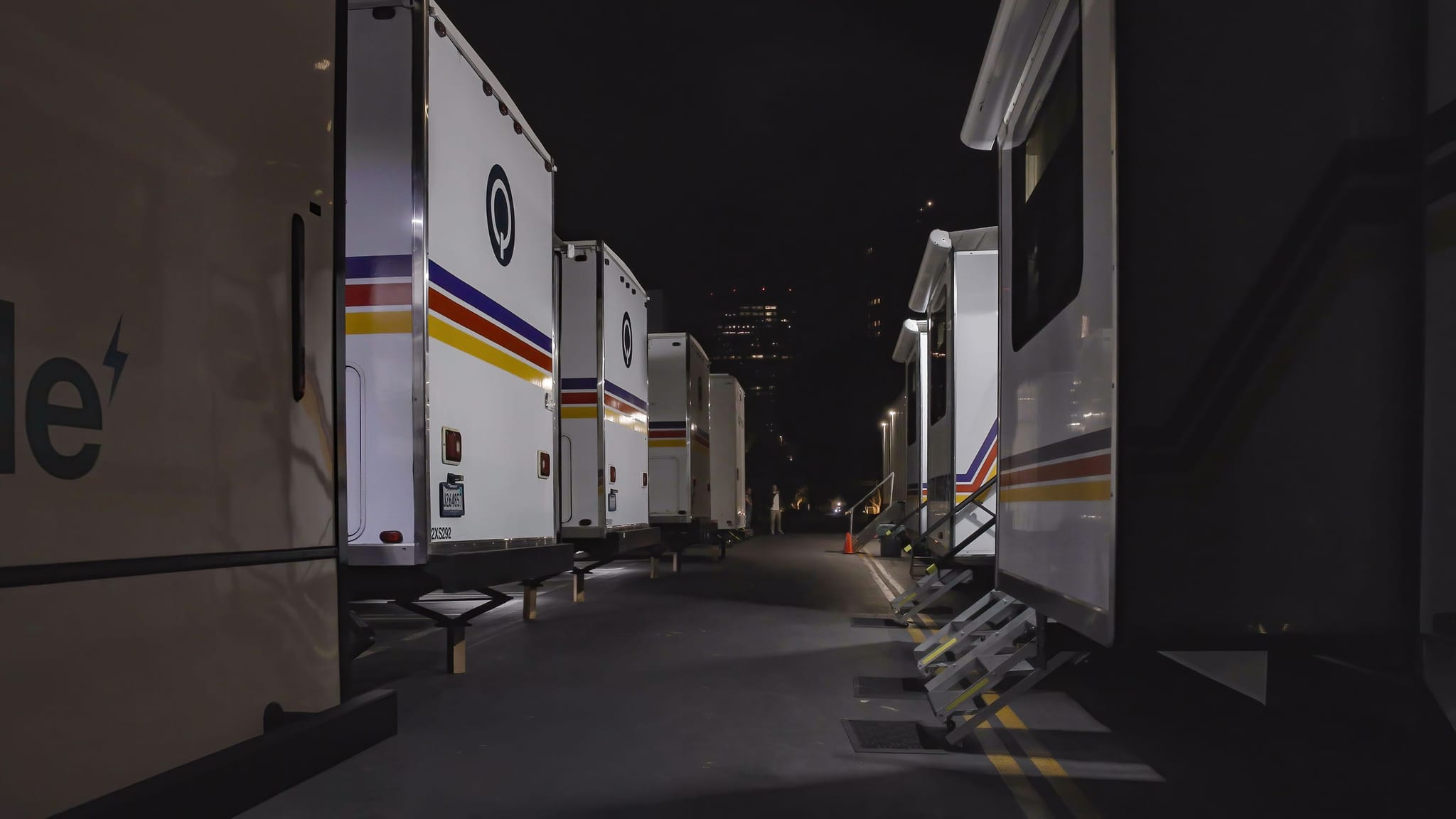 White trailers with "STAR WAGGONS" branding and retro stripes, parked with steps extended at night.