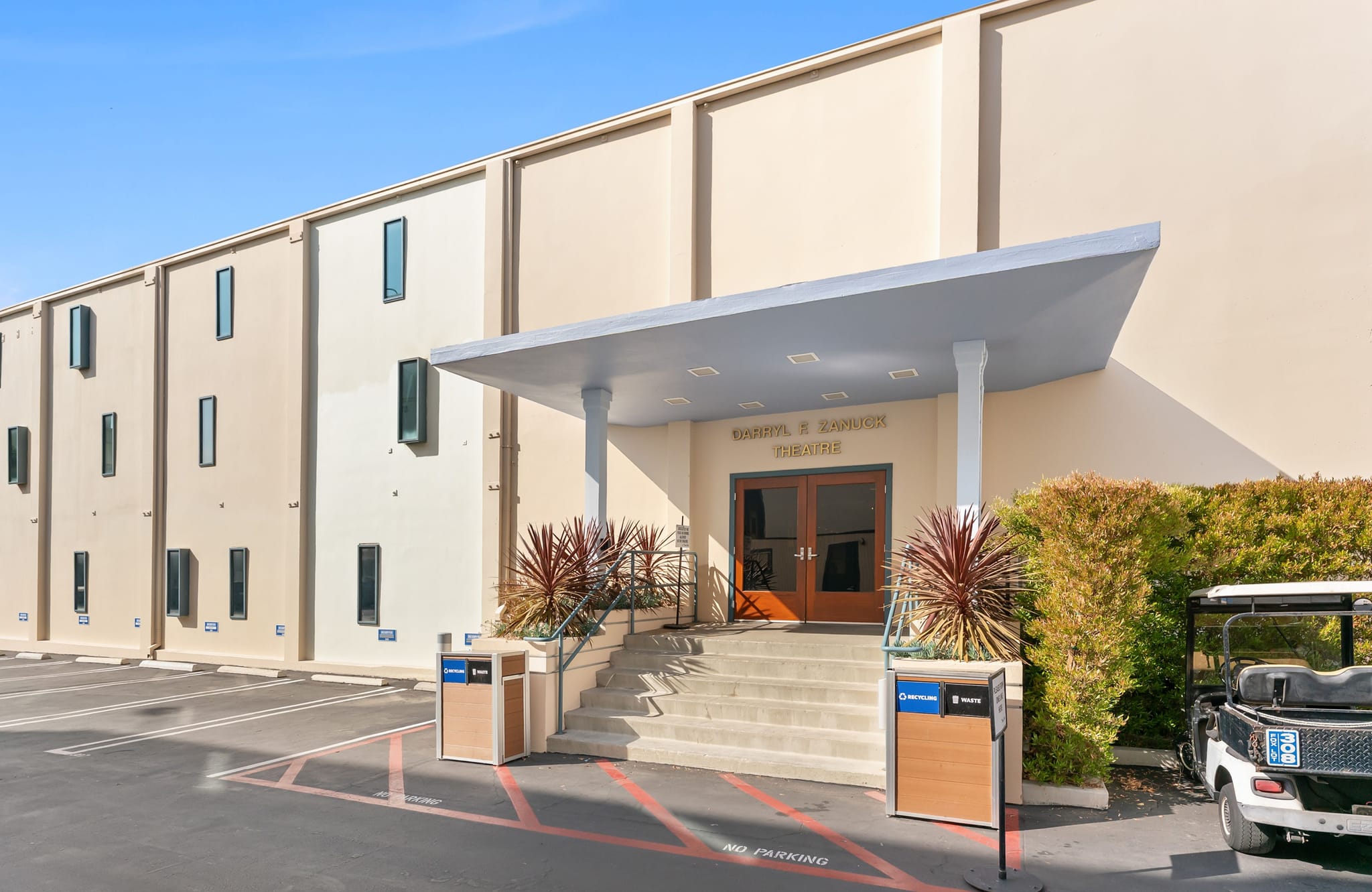 Barbara E. Johnson Theatre building entrance with steps, a canopy, and an adjacent parking lot.
