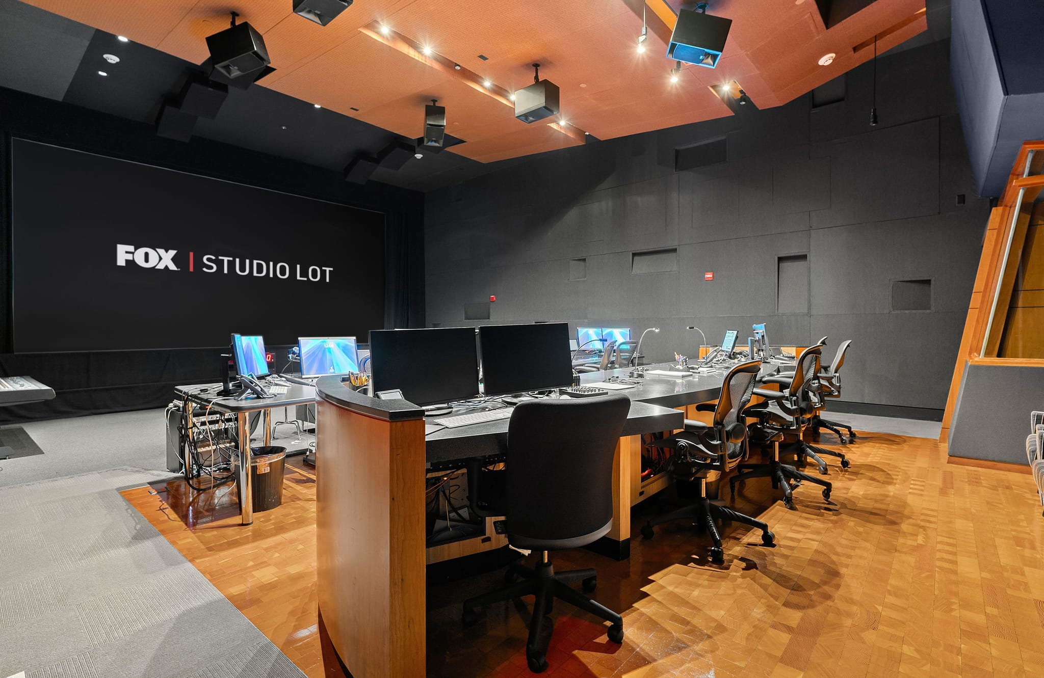 Fox Studio Lot control room with a large screen, production console, and multiple workstations.